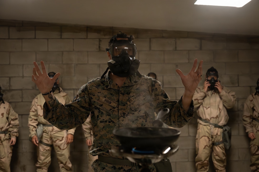 U.S. Marine Corps Sgt. Anthony Yordi, a chemical, biological, radiological and nuclear defense specialist with 2nd Battalion, 1st Marine Regiment, instructs Marines on gas chamber procedures during an Intermediate Location (ILOC) event held at Camp Pendleton, California, Feb. 9, 2026. ILOC is a pre-deployment event to ensure readiness, emphasizing small-unit leadership roles and responsibilities. (U.S. Marine Corps photo by Lance Cpl. Claire Cheney)