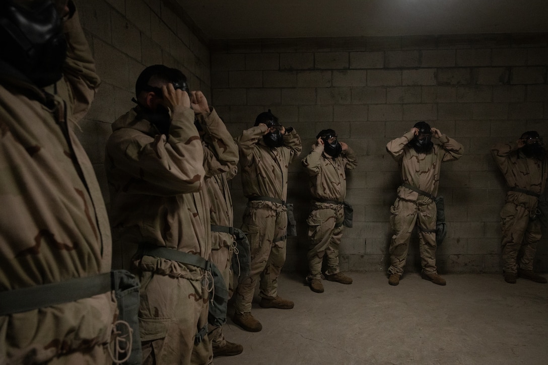 U.S. Marines with 1st Battalion, 25th Marine Regiment, break gas mask seals during an Intermediate Location (ILOC) event held at Camp Pendleton, California, Feb. 9, 2026. ILOC is a pre-deployment event to ensure readiness, emphasizing small-unit leadership roles and responsibilities. (U.S. Marine Corps photo by Lance Cpl. Claire Cheney)
