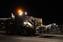 U.S. Air Force Airman 1st Class Matthew Delaney, 437th Airlift Wing air transportation specialist, operates a forklift carrying a pallet of luggage returning from Operation Palmetto Reach, a part of Combat Readiness Exercise 2026, at Joint Base Charleston.