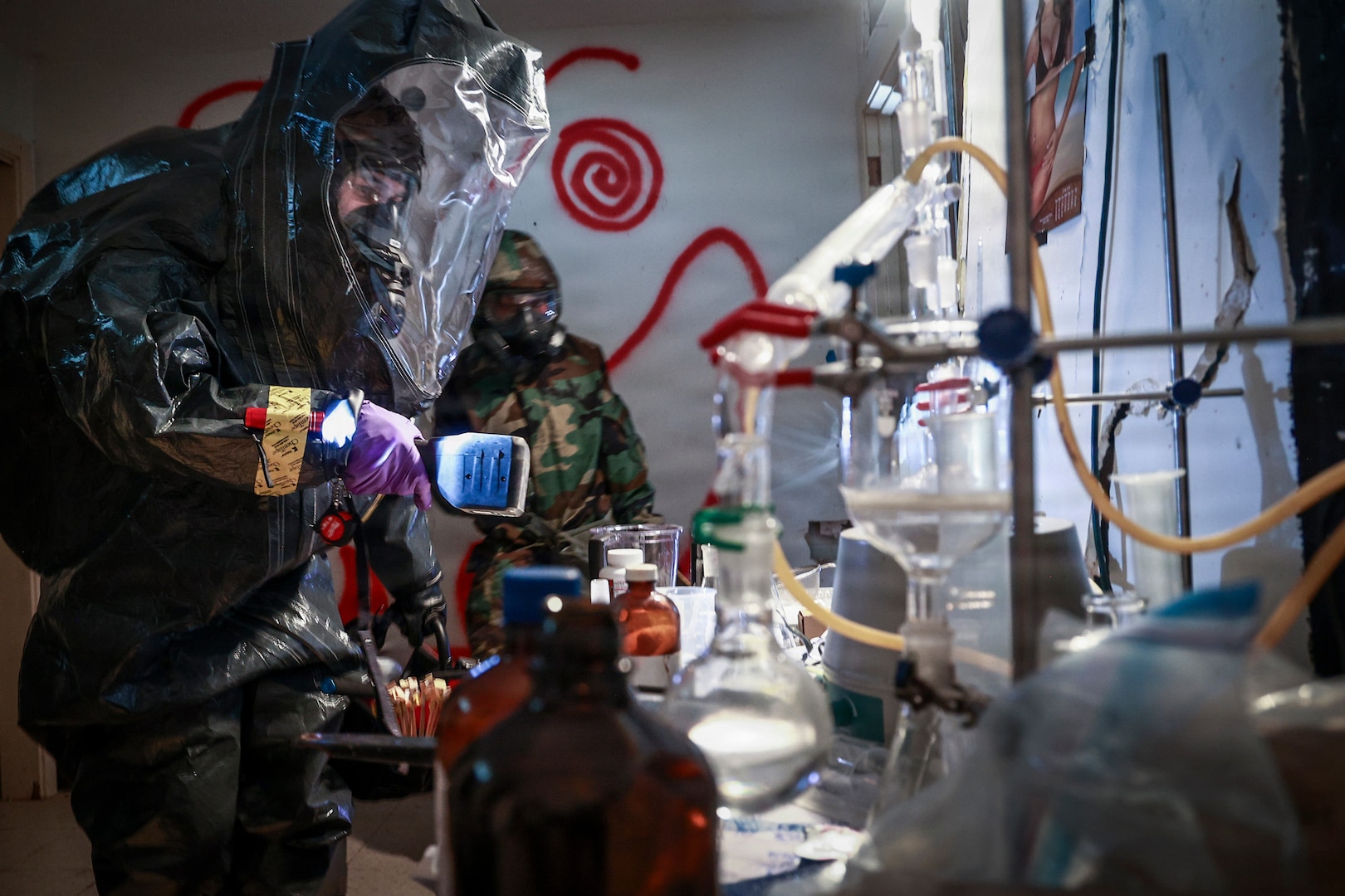 Soldiers of the Guam and New Mexico National Guards, together with Airmen from the Andersen Air Force Base Chemical, Biological, Radiological and Explosives Response Team, survey a clandestine drug laboratory during a multiagency exercise hosted by the Guam Guard, Barrigada, Feb. 18, 2026.