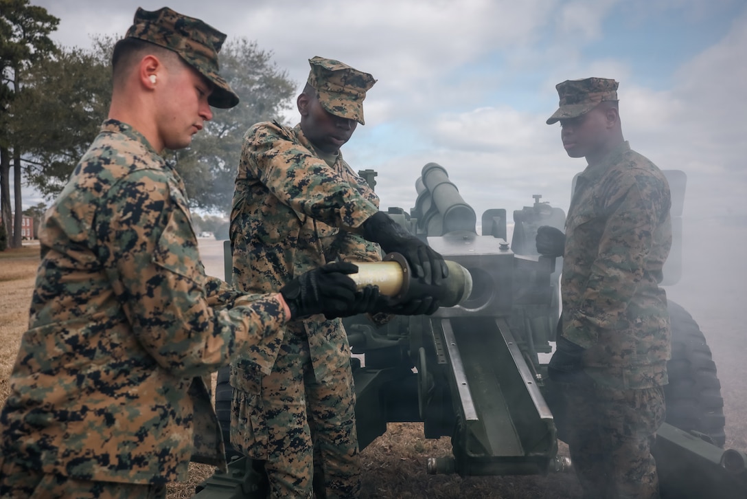 U.S. Marines with 10th Marine Regiment, 2nd Marine Division, load a M2A2 Howitzer during a Presidents Day celeberation on Marine Corps Base Camp Lejeune, North Carolina, Feb. 16, 2026. The 21 Gun Salute, held in honor of Presidents Day in accordance with Naval Regulations, in which each saluting ship, naval station, and installation having a saluting battery shall fire a national salute of 21 guns. (U.S. Marine Corps photo by Lance Cpl. Frank Sepulveda Torres)