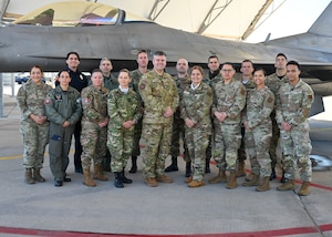 U.S. Air Force Col. Brian Gavitt, Air Forces Southern command surgeon, center, and the Fuerza Aérea Argentina (FAA) pose for a photo in front of an F-16 Fighting Falcon aircraft, at Morris Air National Guard Base, Arizona, Jan. 9, 2026. During the visit, AFSOUTH connected the FAA delegation with subject matter experts across multiple mission areas, including infrastructure, weapons systems and aerospace medicine, to support the development of a comprehensive and sustainable F-16 program for the partner nation. (U.S. Air Force photo by Staff Sgt. Abbey Rieves)