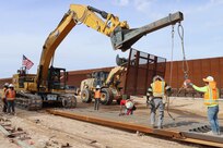 The U.S. Army Corps of Engineers contractors dig trenches and install border panels at the west end of the BMGR-1 project site Jan. 28 near Yuma, Arizona. USACE is replacing permanent border barriers along the southern border of the U.S. at the direction of the U.S. Army by the Secretary of War, in response to the presidential national emergency declaration dated Jan. 20, 2025, authorizing the use of Section 2803 of Title 10, U.S. Code. (No one in this image crossed the international border) (Photo by Robert DeDeaux USACE PAO).