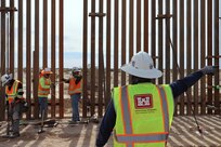 The U.S. Army Corps of Engineers contractors dig trenches and install border panels at the west end of the BMGR-1 project site Jan. 28 near Yuma, Arizona. USACE is replacing permanent border barriers along the southern border of the U.S. at the direction of the U.S. Army by the Secretary of War, in response to the presidential national emergency declaration dated Jan. 20, 2025, authorizing the use of Section 2803 of Title 10, U.S. Code. (No one in this image crossed the international border) (Photo by Robert DeDeaux USACE PAO).