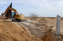 The U.S. Army Corps of Engineers contractors dig trenches and install border panels at the west end of the BMGR-1 project site Jan. 28 near Yuma, Arizona. USACE is replacing permanent border barriers along the southern border of the U.S. at the direction of the U.S. Army by the Secretary of War, in response to the presidential national emergency declaration dated Jan. 20, 2025, authorizing the use of Section 2803 of Title 10, U.S. Code. (No one in this image crossed the international border) (Photo by Robert DeDeaux USACE PAO).