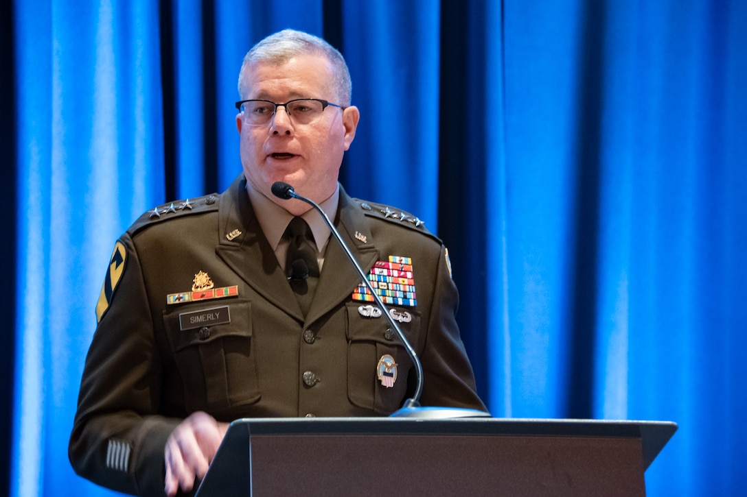 An Army lieutenant general speaks at a podium
