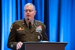 An Army lieutenant general speaks at a podium