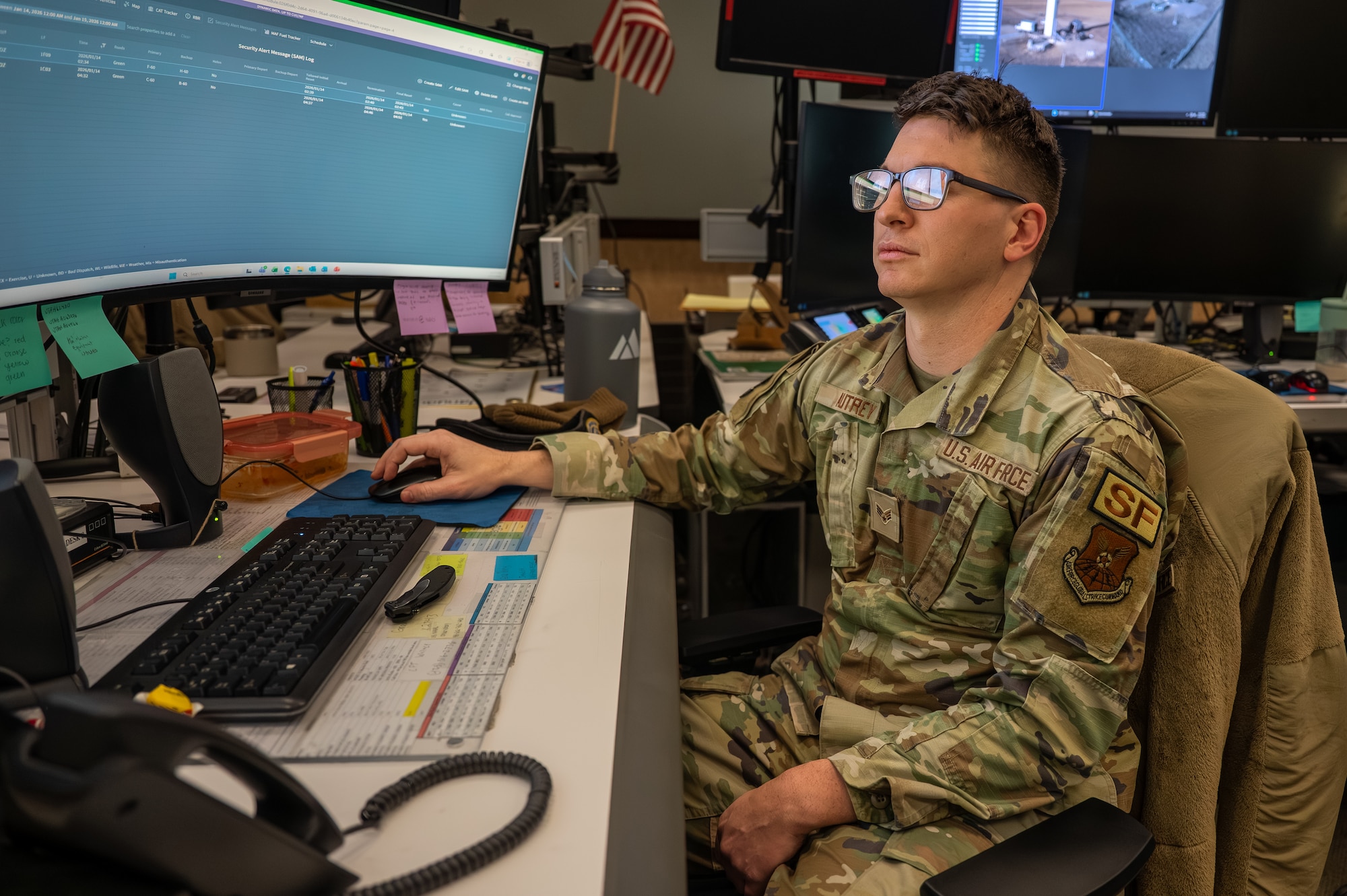 Uniformed service member operating a computer.