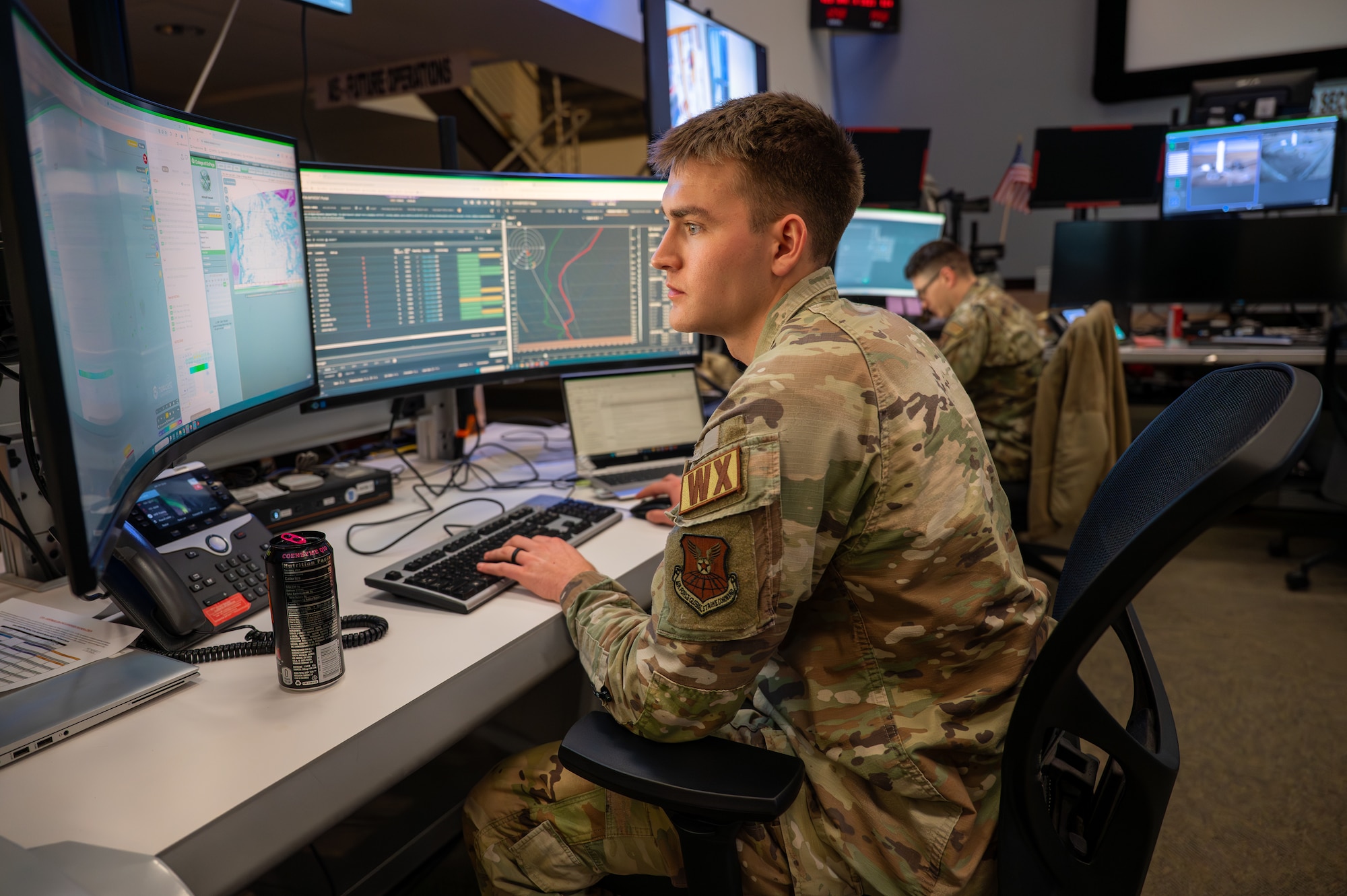 Uniformed service member typing on a computer.