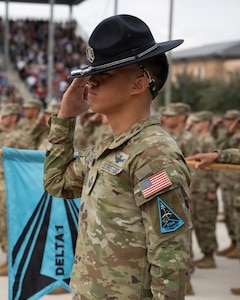 U.S. Space Force Tech. Sgt. Darien Concepcion, a military training instructor assigned to Detachment 3, Space Delta 1, renders a salute during a “Coin and Retreat Ceremony” as part of U.S. Air Force and U.S. Space Force Basic Military Training graduation events, Joint Base San Antonio-Lackland, Texas, Feb. 19, 2026. During the “Coin and Retreat Ceremony,” Airmen and Guardians receive the coveted Airmen or Guardian coin that signifies their transition from trainee to graduate. Upon presentation of their coin by their Military Training Instructor, trainees officially become either an Airman or Guardian. Space Force Guardians complete BMT alongside Air Force recruits at JBSA-Lackland, the sole BMT installation for both services. (U.S. Air Force photo by Jonathan R. Mallard)