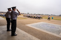 U.S. Space Force Chief of Space Operations Gen. Chance Saltzman and Chief Master Sergeant of the Space Force John Bentivegna render salutes as a flight of graduating Guardians perform a pass-in-review during a U.S. Air Force and U.S. Space Force Basic Military Training graduation parade, Joint Base San Antonio-Lackland, Texas, Feb. 19, 2026. Saltzman and Bentivegna presided over the BMT graduation ceremony after engaging with military training instructors and the service's newest Guardians throughout a multi-day visit to JBSA. (U.S. Air Force photo by Jonathan R. Mallard)