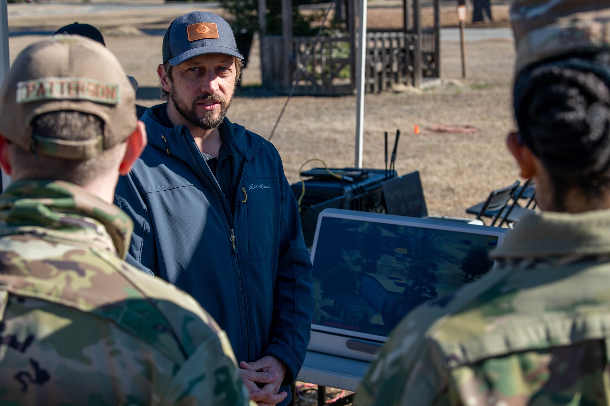 A photo of a man speaking in a group.