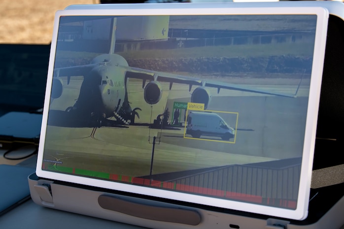 A photo of a screen displaying the live camera feed from a flying drone.