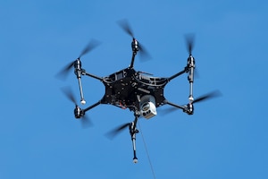 A photo of a drone hovering in the air.