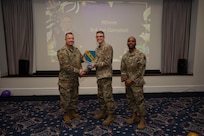 An award winner poses with wing leadership.