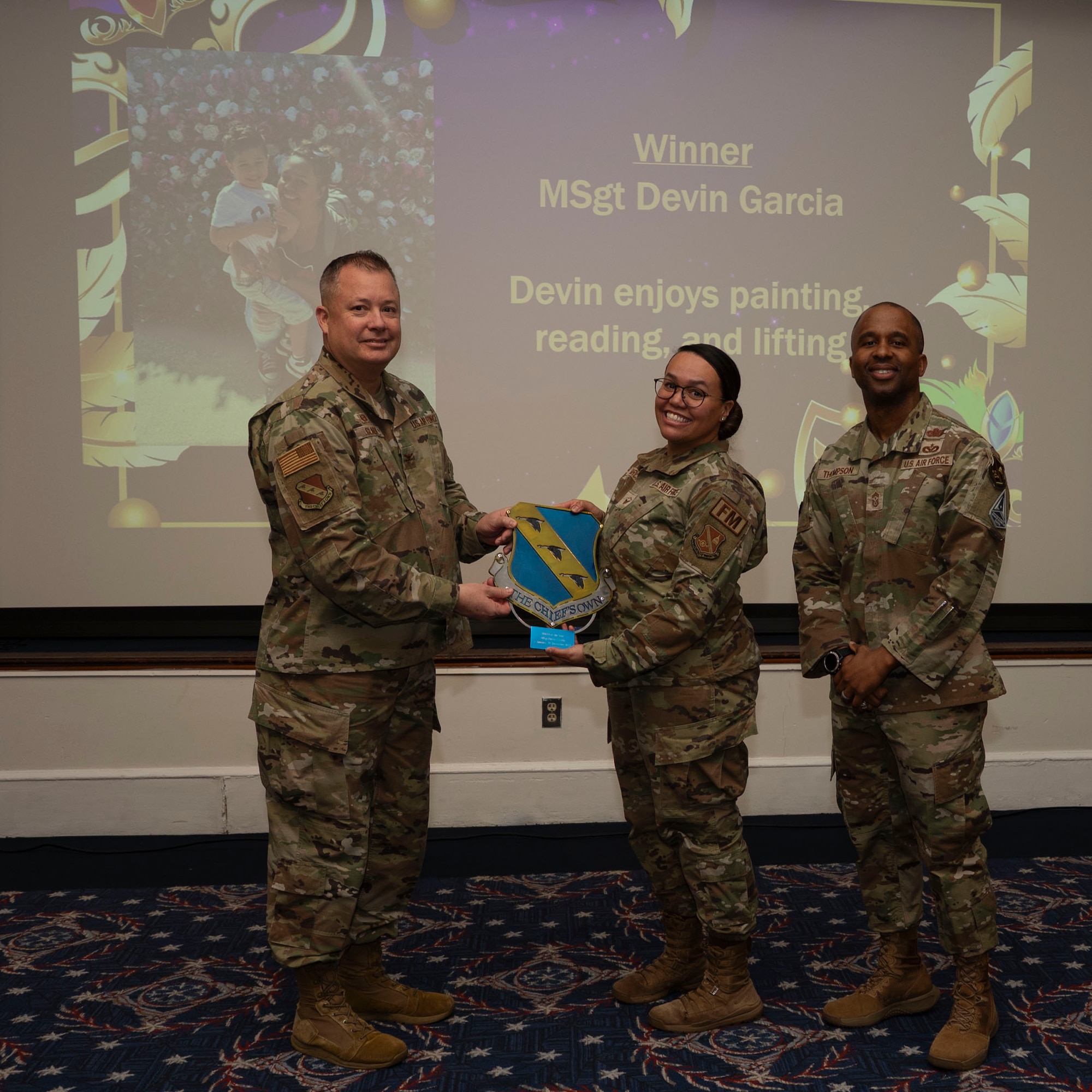 An award winner poses with wing leadership.