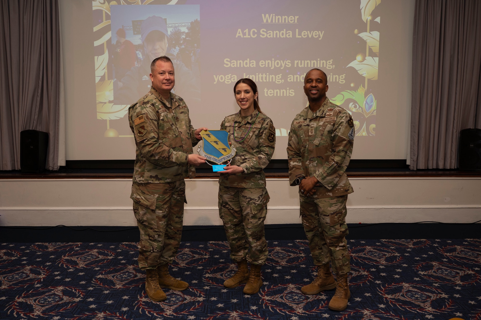 An award winner poses with wing leadership.