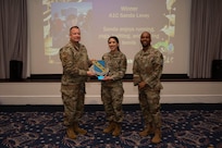An award winner poses with wing leadership.
