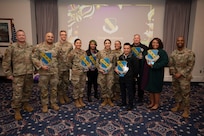 Nine award winners pose standing with wing leadership for a group photo.