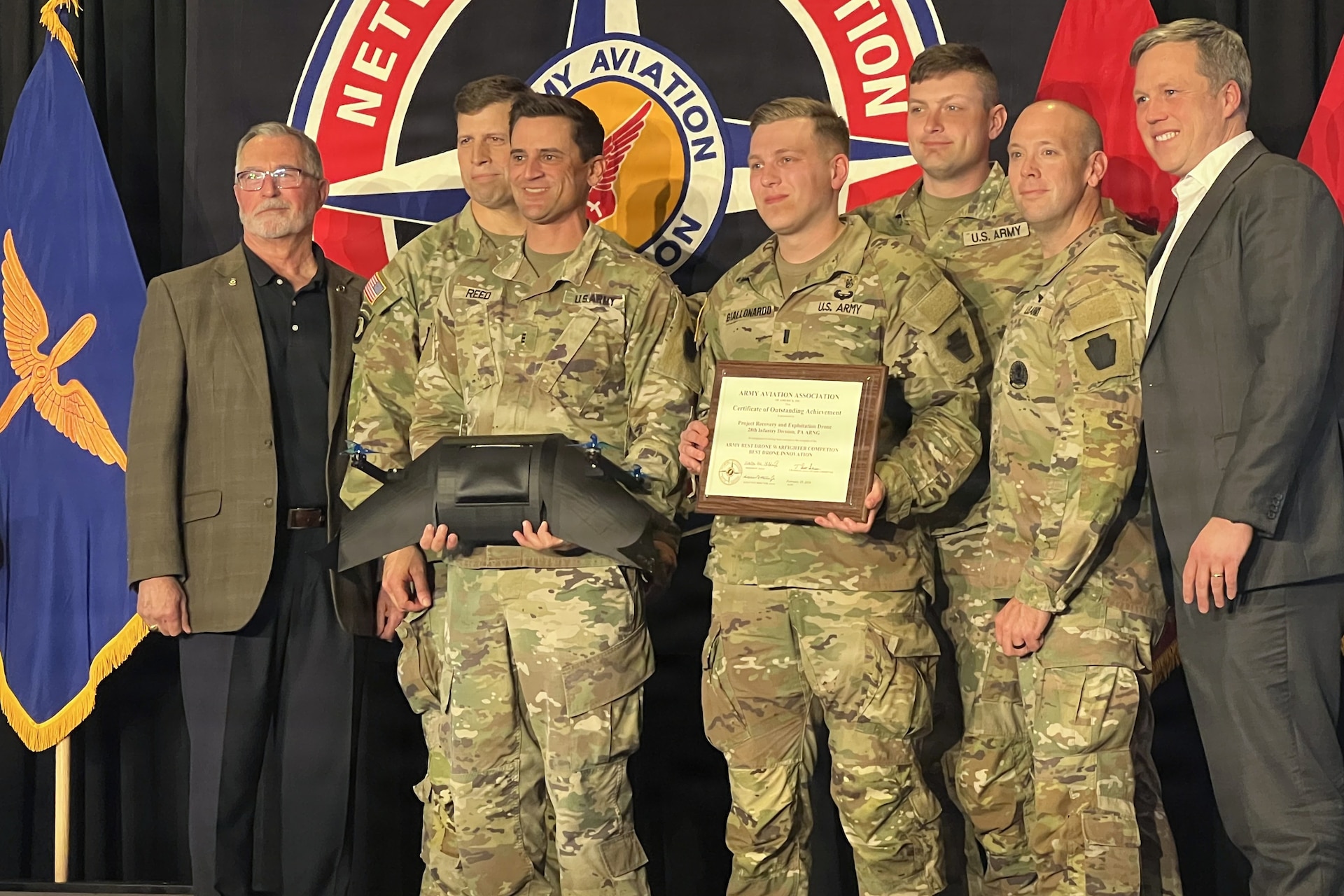 Soldiers from the 28th Infantry Division who won the innovation category at the U.S. Army’s inaugural Best Drone Warfighter Competition receive their award from Secretary of the Army Dan Driscoll, right, Feb. 19, 2026, in Huntsville, Alabama. At left is retired Brig. Gen. Timothy J. Edens, senior vice president of the Army Aviation Association of America. (Courtesy photo)