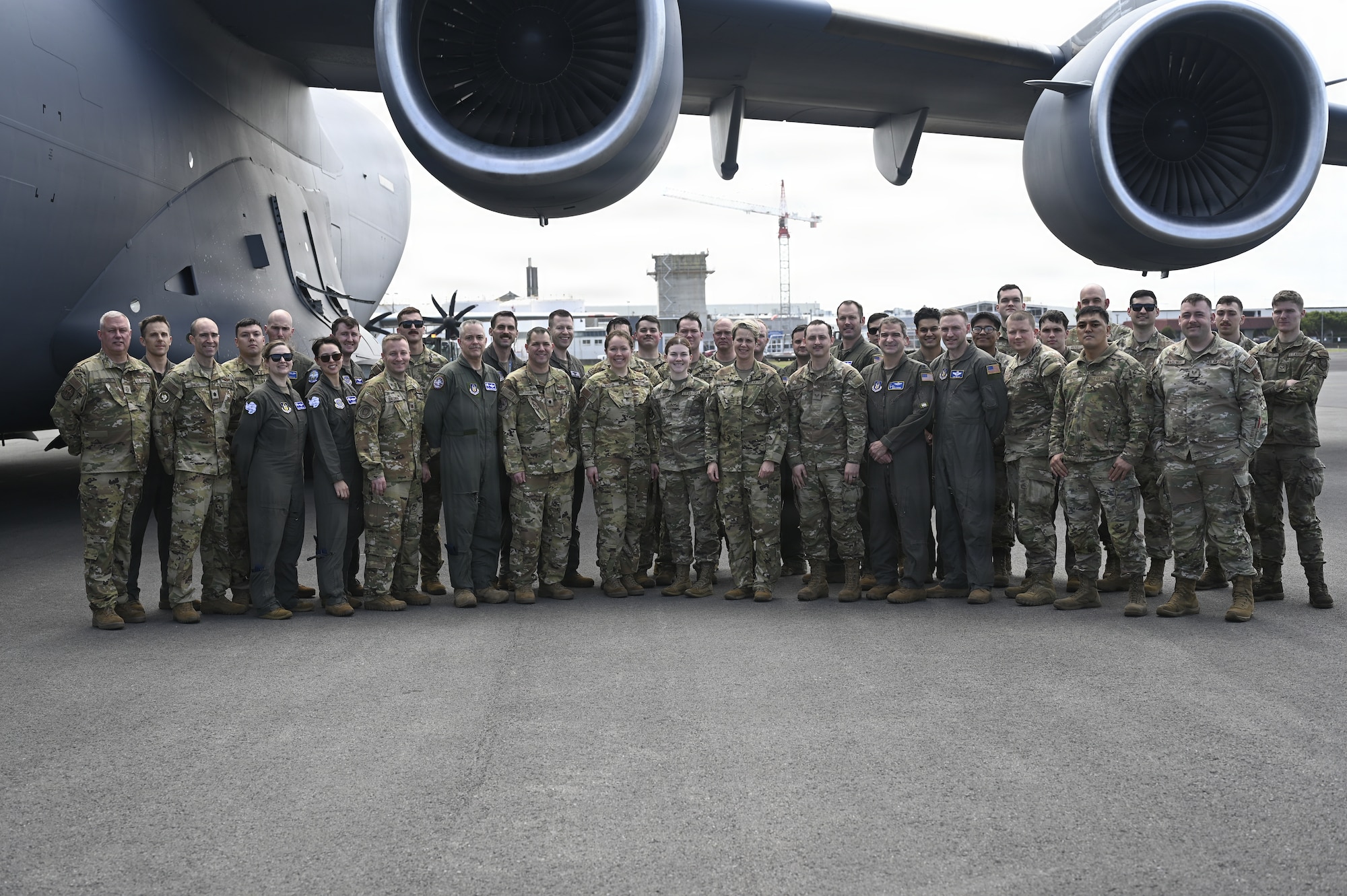 U.S. Airmen supporting Operation Deep Freeze take a group photo with Lt. Gen. Rebecca Sonkiss, Air Mobility Command interim commander, at Christchurch, New Zealand, Feb. 4, 2026. Active Duty and Reserve Airmen flew from McChord Field to New Zealand to support the National Science Foundation with cargo and personnel airlift. (U.S. Air Force photo by Staff Sgt. Ethan Sherwood)