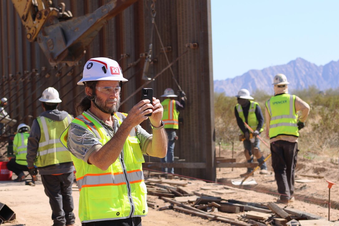 U.S. Army Corps of Engineers’ Arthur Eyrich, a contract specialist assigned to the South Pacific Border Task Force, collects images of construction progress at the BMGR-1 project site near Feb. 9 near Yuma, Arizona. USACE is replacing permanent border barriers along the southern border of the U.S. at the direction of the U.S. Army by the Secretary of War, in response to the presidential national emergency declaration dated Jan. 20, 2025, authorizing the use of Section 2803 of Title 10, U.S. Code. (Photo by Robert DeDeaux USACE PAO)
