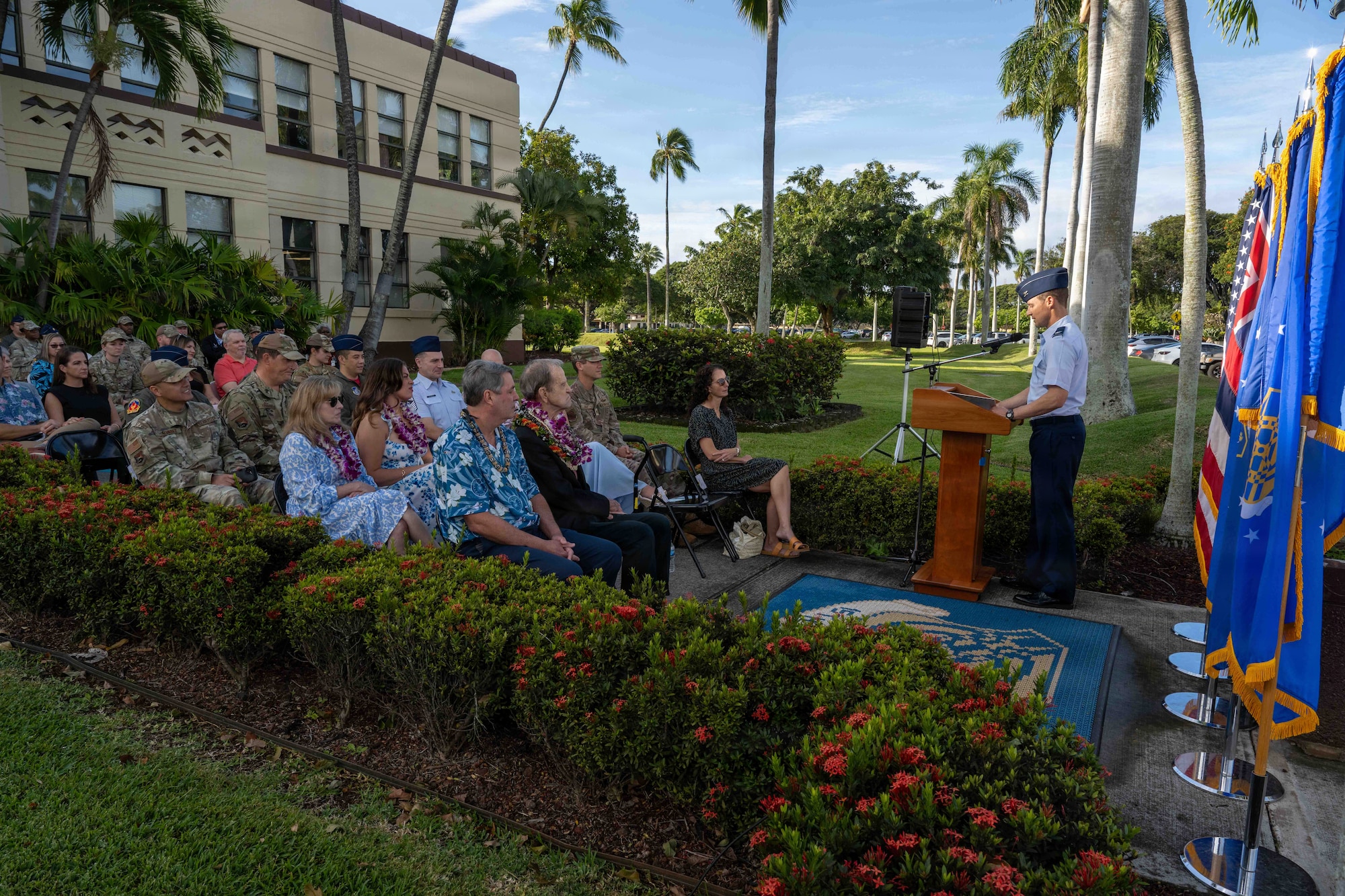 A man speaks in front of a crowd.