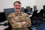 U.S. Air Force Senior Airman Matthew Wright, a cyber analyst with the 267th Intelligence Squadron, poses for a photo on Otis Air National Guard Base, Massachusetts, Feb. 18, 2026. Wright recently completed a challenging five-month fellowship program at the Massachusetts Institute of Technology through a unique military collaboration between the Department of the Air Force Artificial Intelligence Accelerator program and the private research university. (Air National Guard photo by Senior Airman Julia Ahaesy)