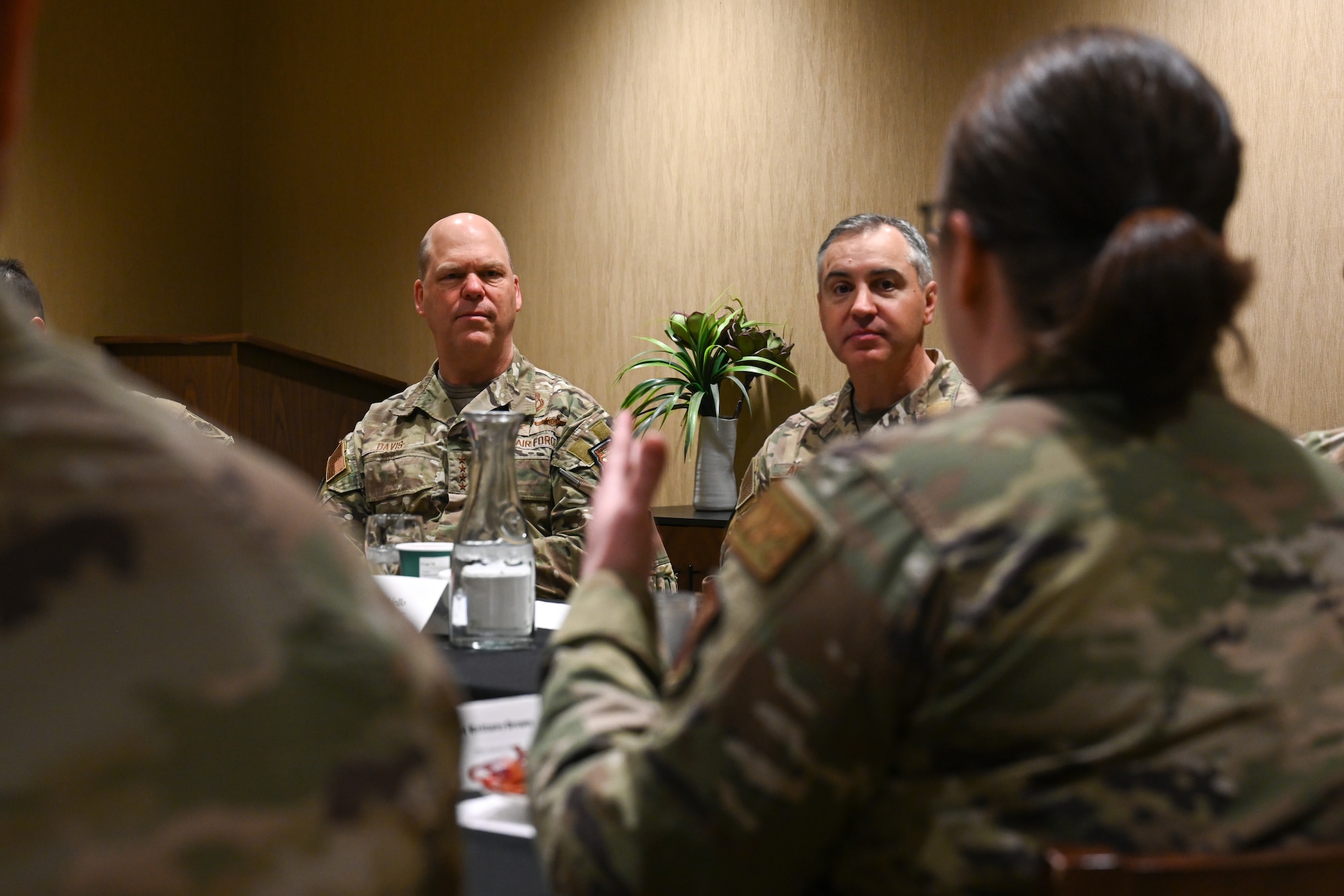 U.S. Air Force Gen. S.L. Davis, commander of Air Force Global Strike Command, left, and Chief Master Sergeant Shawn M. Aiello, AFGSC command chief, right, speak with Airmen during a visit to Ellsworth Air Force Base, S.D., Feb. 18, 2026.