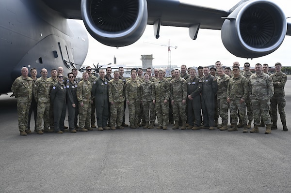 U.S. Airmen supporting Operation Deep Freeze take a group photo with Lt. Gen. Rebecca Sonkiss, Air Mobility Command interim commander, at Christchurch, New Zealand, Feb. 4, 2026. Active Duty and Reserve Airmen flew from McChord Field to New Zealand to support the National Science Foundation with cargo and personnel airlift. (U.S. Air Force photo by Staff Sgt. Ethan Sherwood)