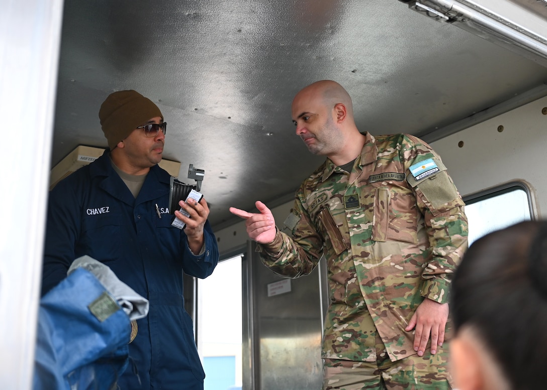 A member of the Arizona Air National Guard and the Fuerza Aérea Argentina (FAA) discuss hydrazine recovery and mitigation techniques at Morris Air National Guard Base, Arizona, Jan. 7, 2026. The knowledge exchange supported the FAA’s Peace Condor program, and its initiative in developing plans and programs necessary to operate and sustain a modernized fighter platform. (U.S. Air Force photo by Staff Sgt. Abbey Rieves)