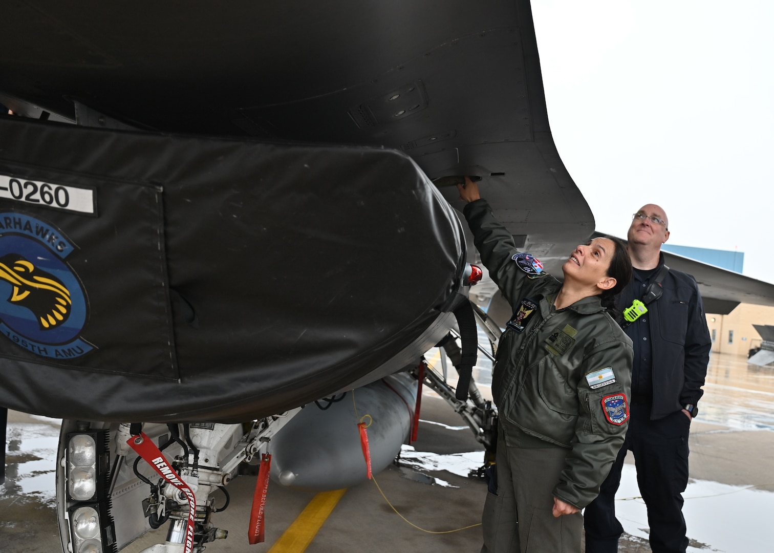 A member of the Fuerza Aérea Argentina (FAA) examines a F-16 Fighting Falcon aircraft at Morris Air National Guard Base, Arizona, Jan 7, 2026. Air Forces Southern helped facilitate the knowledge exchange with the 162nd Wing in support of the Argentine air force’s Peace Condor program—an initiative focused on the integration of six newly acquired F-16 Fighting Falcon aircraft into its fleet, received in late 2025. (U.S. Air Force photo by Staff Sgt. Abbey Rieves)