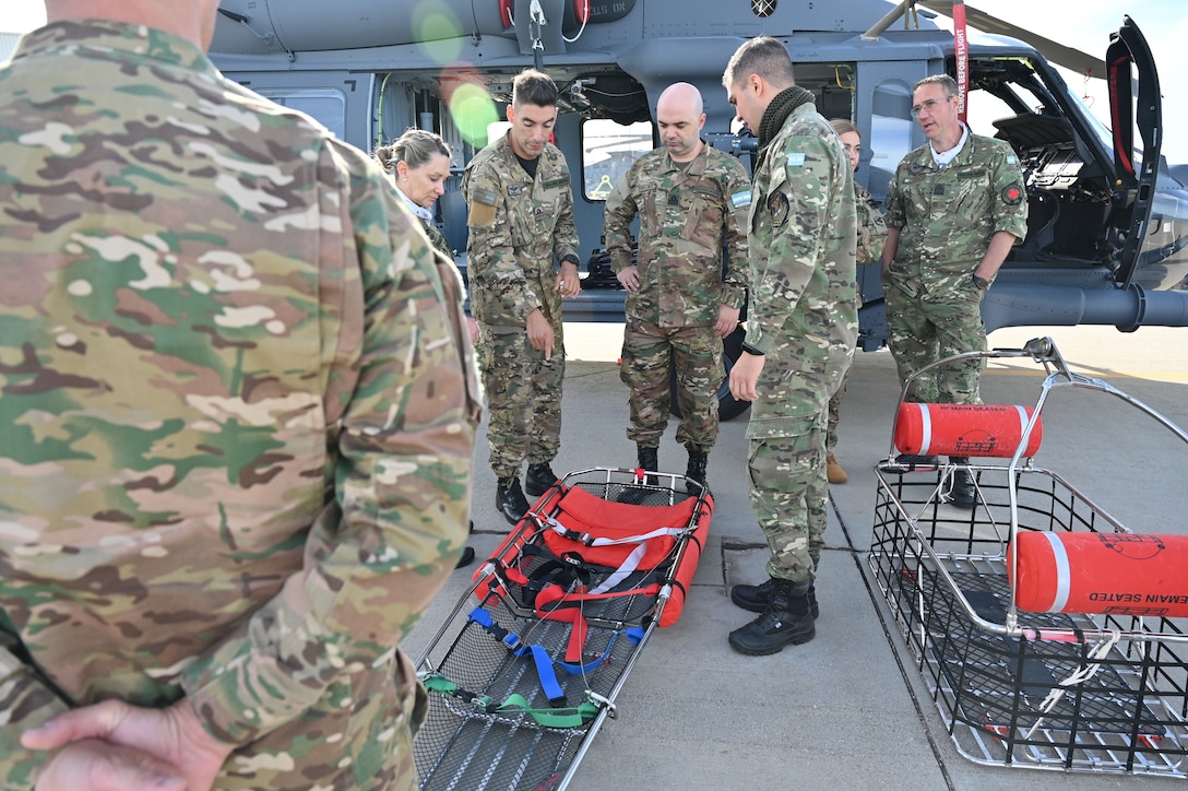 Fuerza Aérea Argentina (FAA) members visit the 305th Rescue Squadron, to discuss combat search and rescue capabilities at Davis-Monthan Air Force Base, Arizona, Jan. 6, 2026. The 305th RQS showcased its CSAR capabilities, which play a vital role to an F-16 program by supporting pilot survivability, mission effectiveness and strategic decision-making. (U.S. Air Force photo by Staff Sgt. Abbey Rieves)