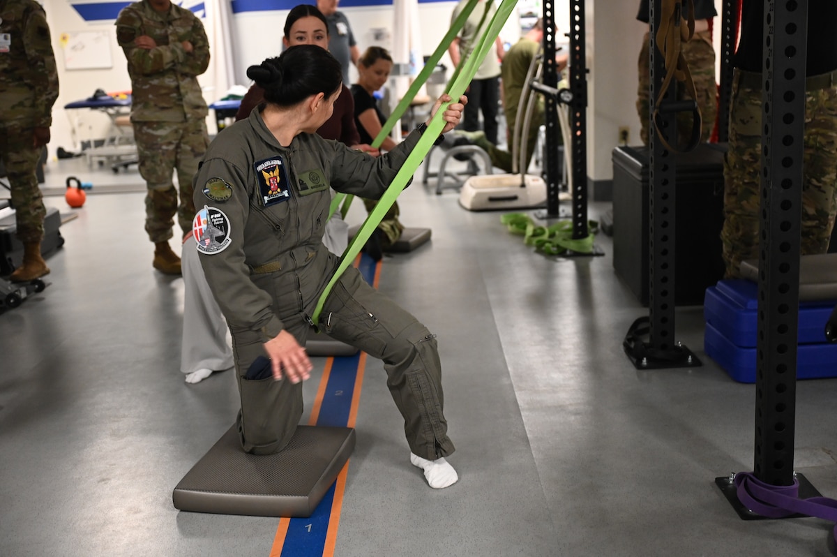 A Fuerza Aérea Argentina (FAA) member practices a physical therapy stretching technique at Davis-Monthan Air Force Base, Arizona, Jan. 6, 2026. The Argentine air force learned whole body health practices designed to support the unique physical demands on F-16 fighter pilots, requiring specialized flight medicine, physical therapy and conditioning. (U.S. Air Force photo by Staff Sgt. Abbey Rieves)