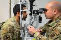 U.S. Air Force Maj. Matthew Tholl, optometrist with the Bolling Medical Squadron, demonstrates an eye exam at Joint Base Anacostia-Bolling, Washington, D.C., Feb. 20, 2026.