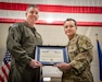 Brig. Gen. Bruce Bancroft, left, the Kentucky National Guard’s assistant adjutant general for Air, presents Col. Aaron Zamora, commander of the 123rd Contingency Response Group, with the Kentucky Governor’s Outstanding Unit Citation during a ceremony at the Kentucky Air National Guard Base in Louisville, Ky., Dec. 14. The award recognizes the group’s exceptional service to citizens across the state and nation from August 2024 to March 2025. (U.S. Air National Guard photo by Master Sgt. Joshua Horton)