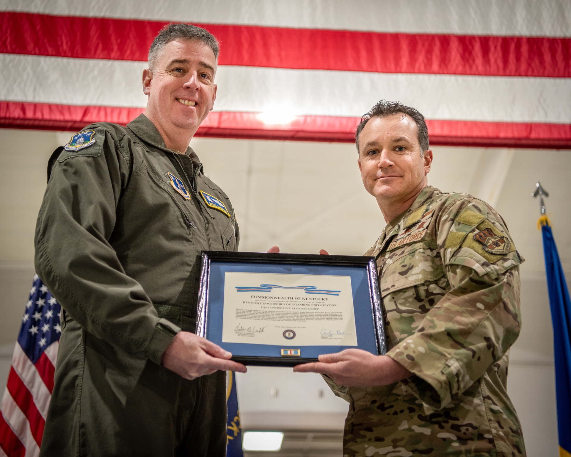 Brig. Gen. Bruce Bancroft, left, the Kentucky National Guard’s assistant adjutant general for Air, presents Col. Aaron Zamora, commander of the 123rd Contingency Response Group, with the Kentucky Governor’s Outstanding Unit Citation during a ceremony at the Kentucky Air National Guard Base in Louisville, Ky., Dec. 14. The award recognizes the group’s exceptional service to citizens across the state and nation from August 2024 to March 2025. (U.S. Air National Guard photo by Master Sgt. Joshua Horton)