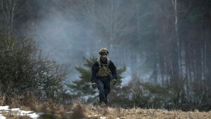 Soldier emplacing obstacles as a part of the Opposing Force