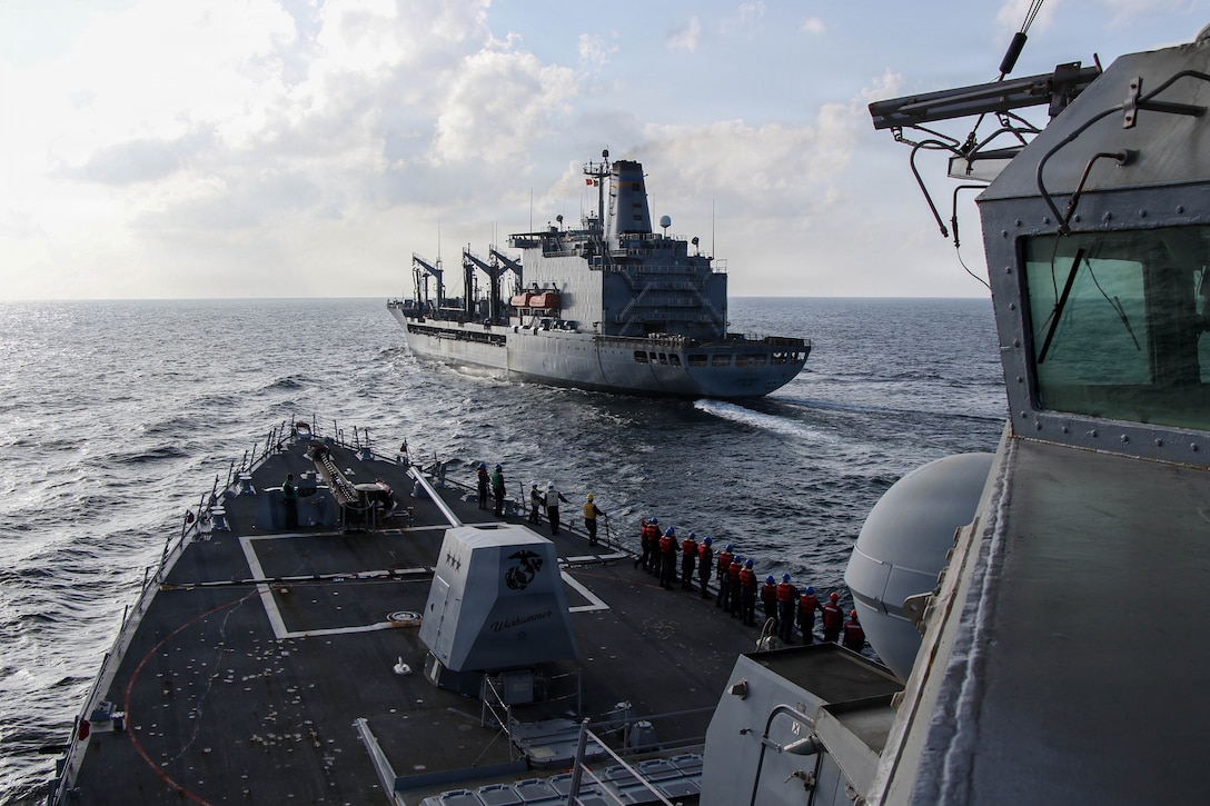Arleigh Burke-class guided-missile destroyer USS Frank E. Petersen Jr. (DDG 121) sails alongside fleet replenishment oiler USNS Henry J. Kaiser (T-AO-187), during a replenishment-at-sea in the Arabian Sea, Feb. 18, 2026. Frank E. Peterson Jr. is deployed to the U.S. 5th Fleet area of operations to support maritime security and stability in the Middle East. (U.S. Navy photo by Mass Communication Specialist 2nd Class Christian Kibler)