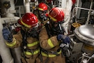 U.S. Sailors combat a simulated fire during a general quarters drill aboard Arleigh Burke-class guided-missile destroyer USS Frank E. Petersen Jr. (DDG 121), in the Arabian Sea, Feb. 11, 2026. Frank E. Peterson Jr. is deployed to the U.S. 5th Fleet area of operations to support maritime security and stability in the Middle East. (U.S. Navy photo by Mass Communication Specialist 2nd Class Christian Kibler)