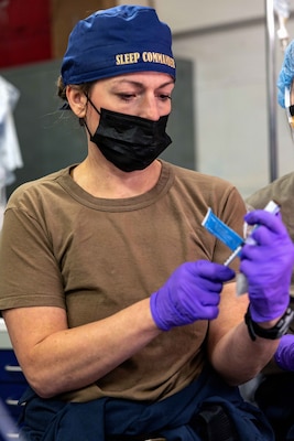Cmdr. Kathryn Miller, from Chesapeake, Virginia, assigned to Medical Department aboard Pre-Commissioning Unit John F. Kennedy (CVN 79), prepares to administer anesthesia prior to the ship’s first at-sea surgery which occurred during Builder’s Trials, Feb. 1, 2026. Builder’s Trials provide an opportunity to test ship systems and components at sea for the first time, and make required adjustments prior to additional underway testing. (U.S. Navy photo by Mass Communication Specialist 1st Class Tyrell K. Morris)