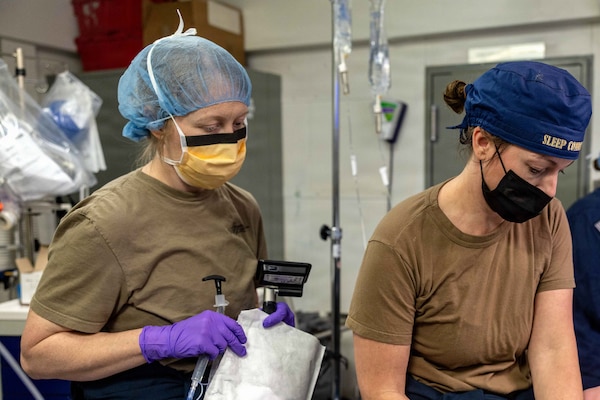 Lt. Cmdr. Rocquelle Dishaw, the ship’s nurse, left, from Sneads Ferry, North Carolina, and Cmdr. Kathryn Miller, from Chesapeake, Virginia, both assigned to Medical Department aboard Pre-Commissioning Unit John F. Kennedy (CVN 79), prepare a patient for the ship’s first at-sea surgery which occurred during Builders Trials, Feb. 1, 2026. Builder’s Trials provide an opportunity to test ship systems and components at sea for the first time, and make required adjustments prior to additional underway testing. (U.S. Navy photo by Mass Communication Specialist 1st Class Tyrell K. Morris)