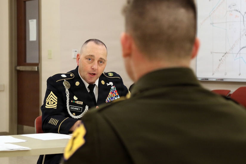 U.S. Army Command Sgt. Maj. Joseph Chearney (left) with the 165th Military Police Battalion, 55th Maneuver Enhancement Brigade, Pennsylvania Army National Guard asks a question to Spc. Ethan Debockler, a military police Soldier with the 28th Military Police Company, during a brigade appearance board in Scranton, Pa. Feb. 21, 2026. (U.S. Army National Guard photo by Sgt. 1st Class Shane Smith)