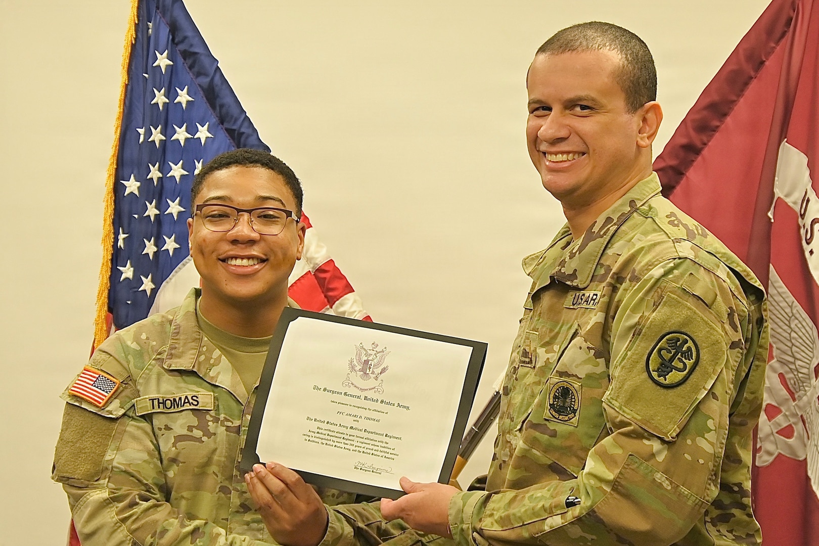 Soldier presents a certificate to a recent 68W graduate