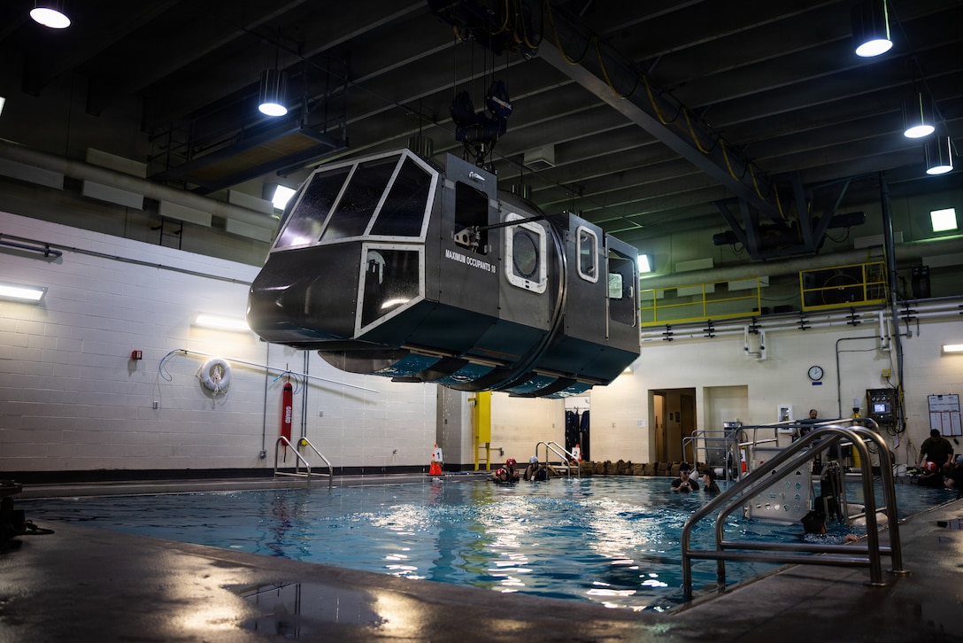 U.S. Marines with Combat Logistics Battalion 22, Combat Logistics Regiment 27, 2nd Marine Logistics Group, execute underwater egress training at Marine Corps Base Camp Lejeune, North Carolina, Feb. 6, 2026. UET provides Marines and Sailors with the skills and confidence to safely evacuate an aircraft submerged in water. (U.S. Marine Corps photo by Lance Cpl. Brady V. Hathaway)