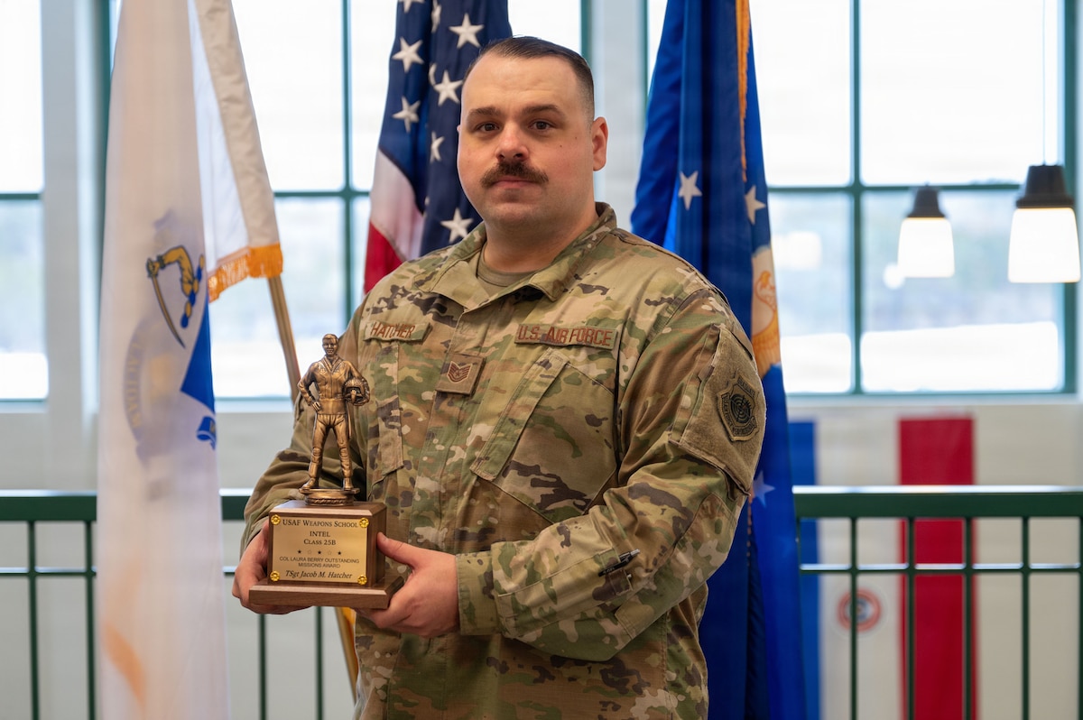 Airman holds an award.