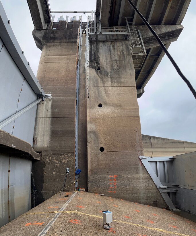 Vertical panorama of dewatered bay with marked gravity stations and gravimeter.