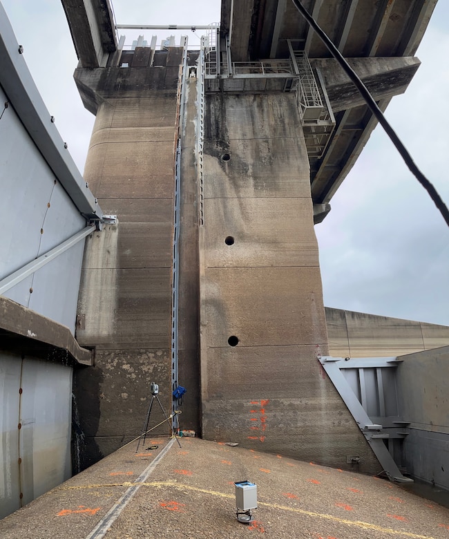 Vertical panorama of dewatered bay with marked gravity stations and gravimeter.