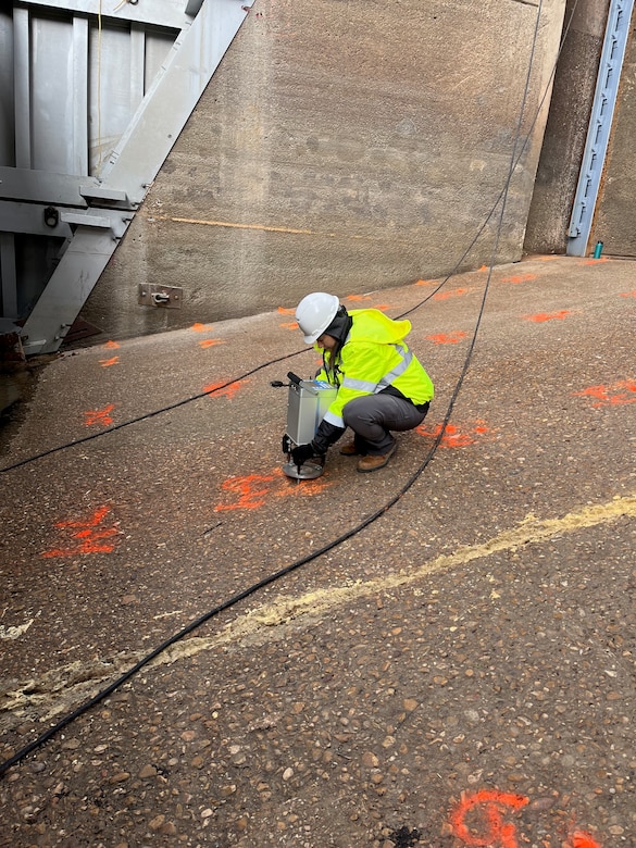 Rebekah Lee, research geophysicist with ERDC's Geotechnical and Structures Lab, using the gravimeter to accurately measure gravity in the dewatered bay.