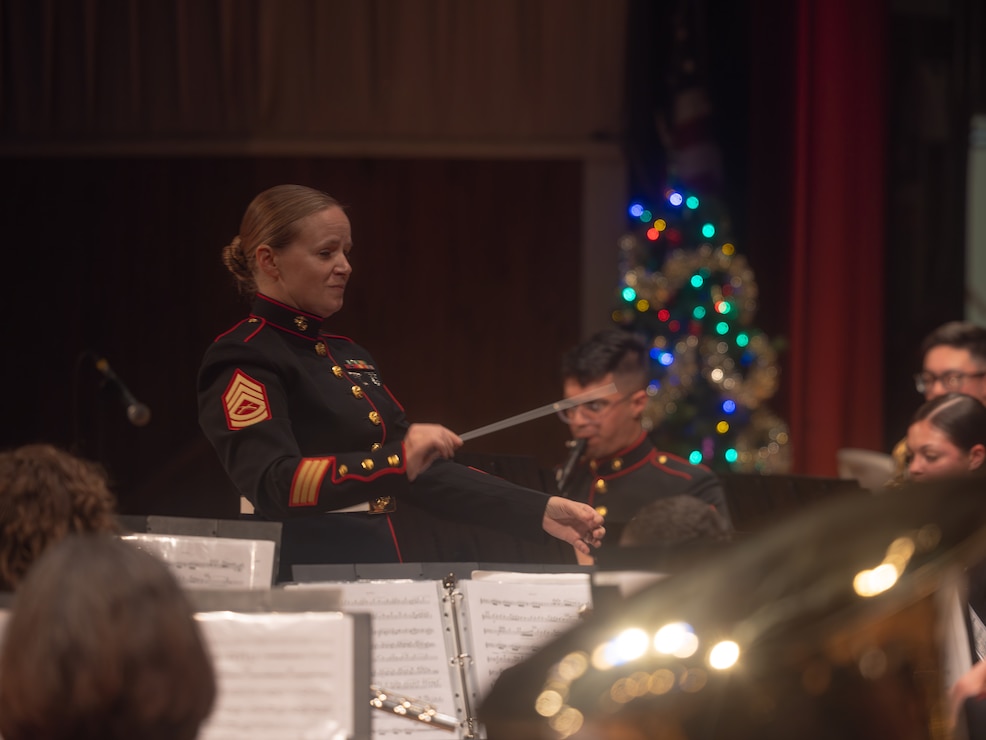 U.S. Marine Corps Gunnery Sgt. Linsey Waller, a Tennessee native, and a conductor with the 2nd Marine Division Band, conducts during an annual holiday concert at the Marine Corps Community Services Camp Lejeune Base Theater at Marine Corps Base Camp Lejeune, North Carolina, Dec. 5, 2025
